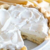 whole banana cream pie with slice taken