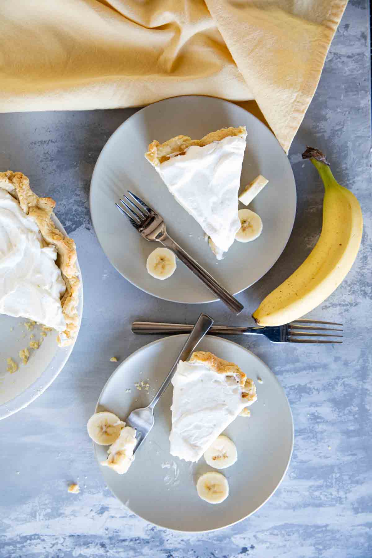 overhead view of 2 slices of banana cream pie on plates