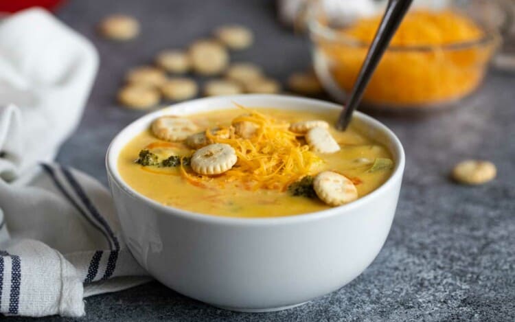 bowl of Broccoli Cheddar Soup topped with cheese and crackers