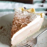 slice of chocolate cream pie with cocoa powder on top