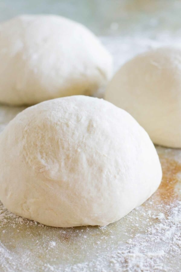 balls of homemade pizza dough on a counter