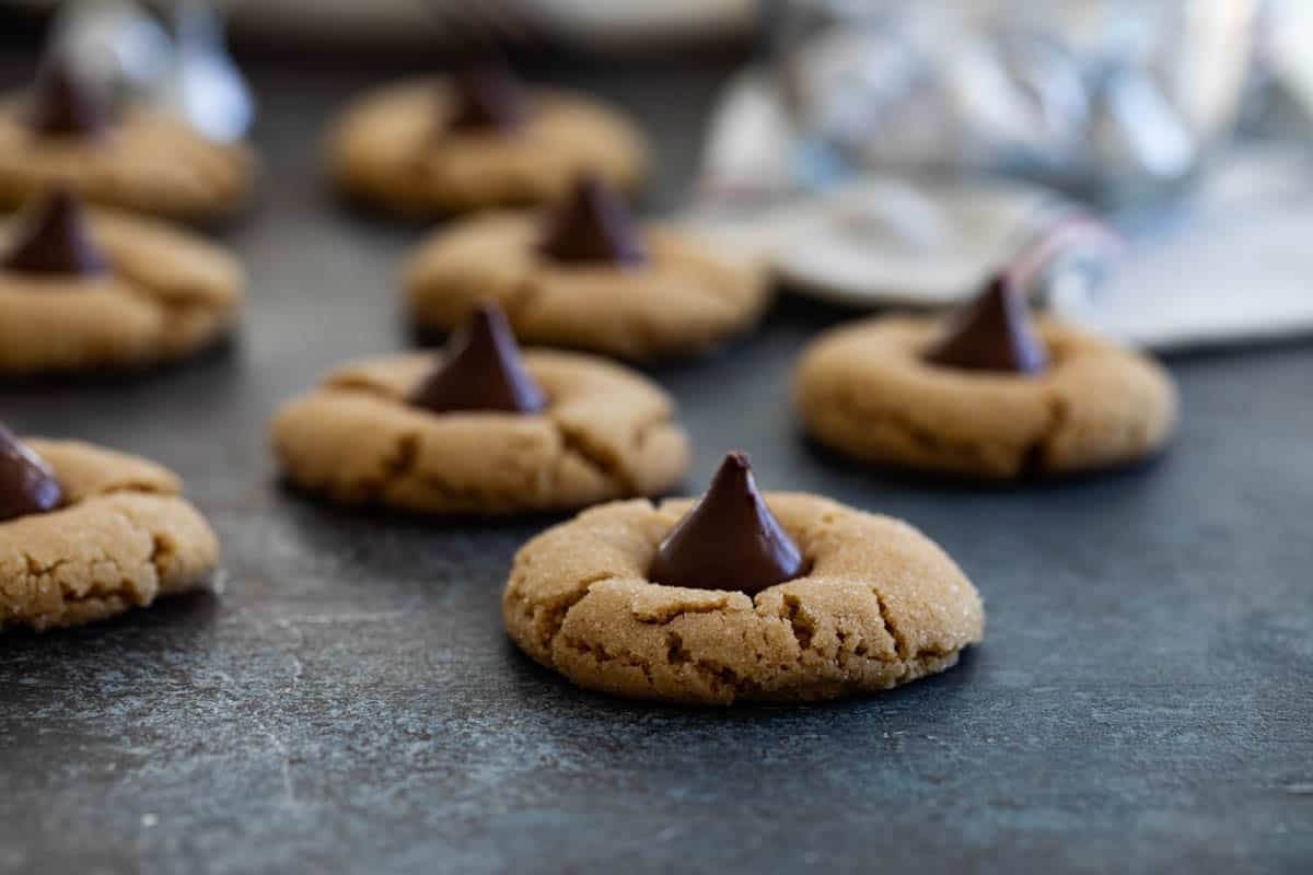 peanut butter blossoms with hershey's kisses in the background