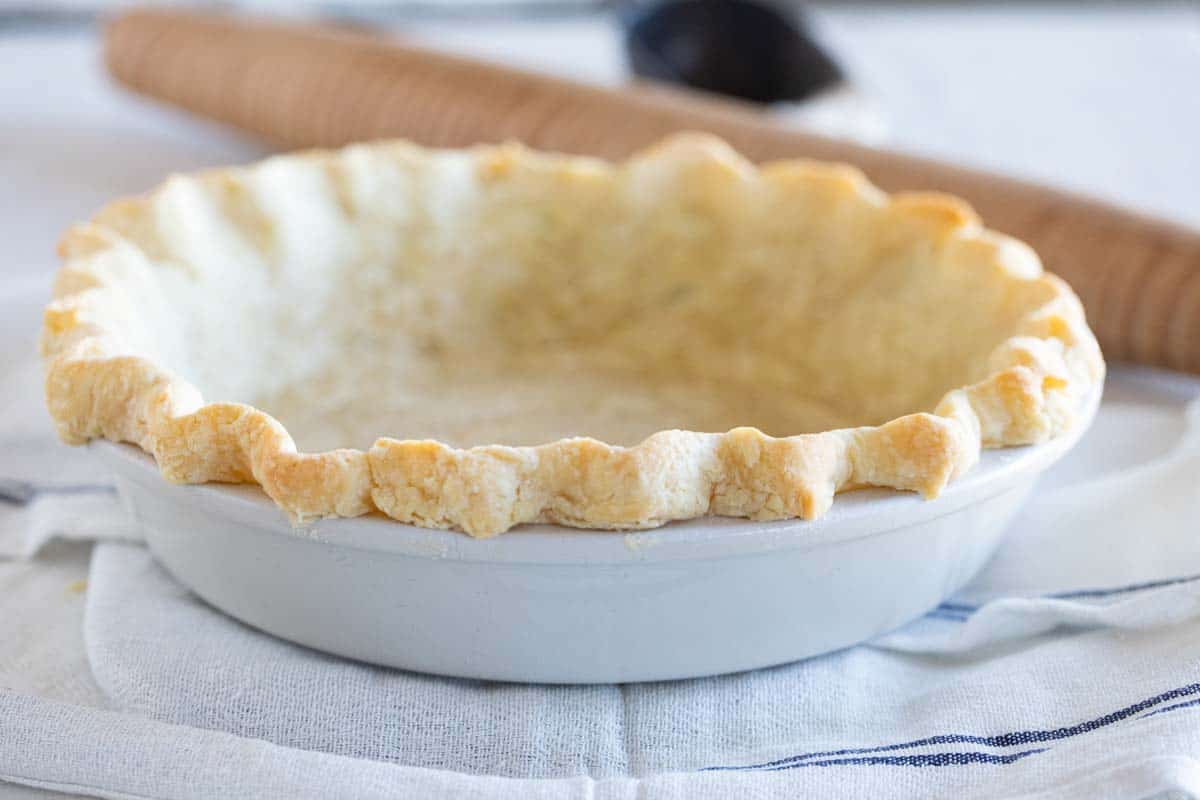 baked pie crust in a white pie dish