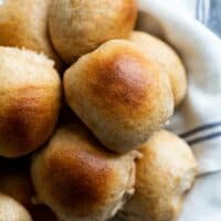 overhead view of basket of whole wheat rolls