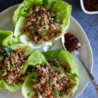 overhead view of chicken lettuce wraps with chili sauce