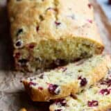 slices of cranberry orange bread with fresh cranberries