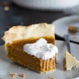 slice of pumpkin pie with forkfull taken from it