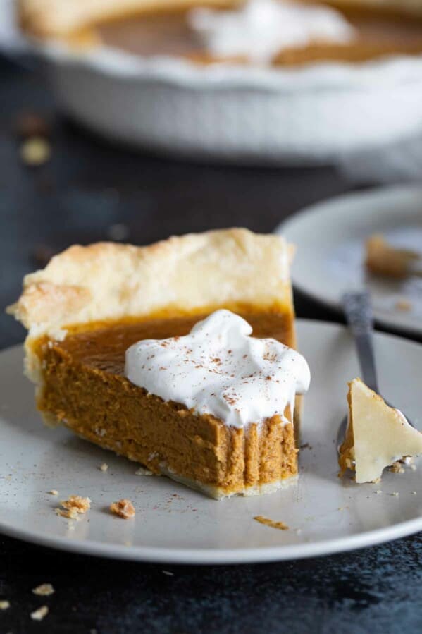 slice of pumpkin pie with forkfull taken from it