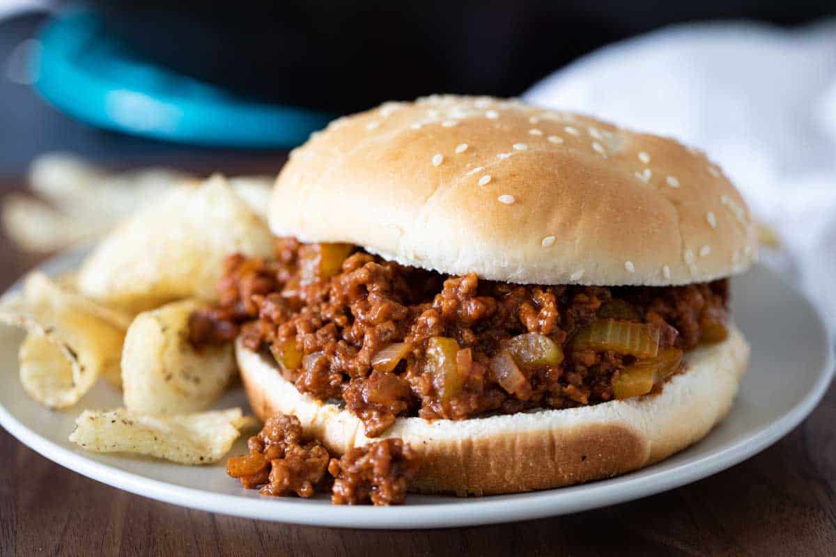 sloppy joe on a plate with potato chips