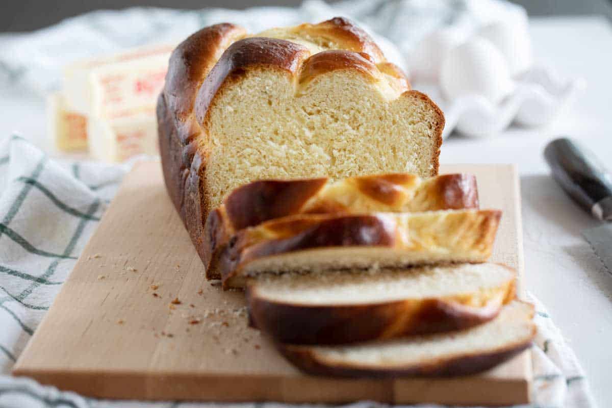 loaf of sliced brioche on a cutting board