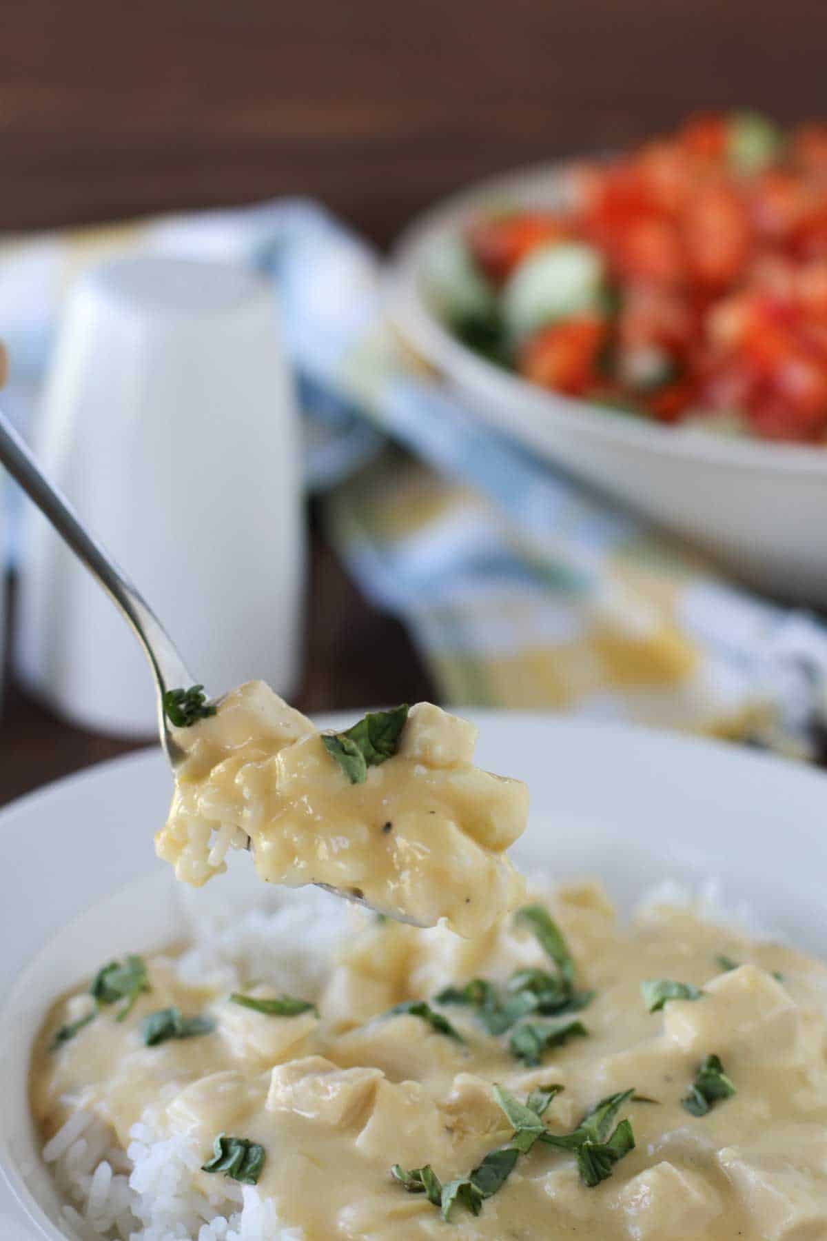 Cheesy Sour Cream Chicken with a fork taking a bite.