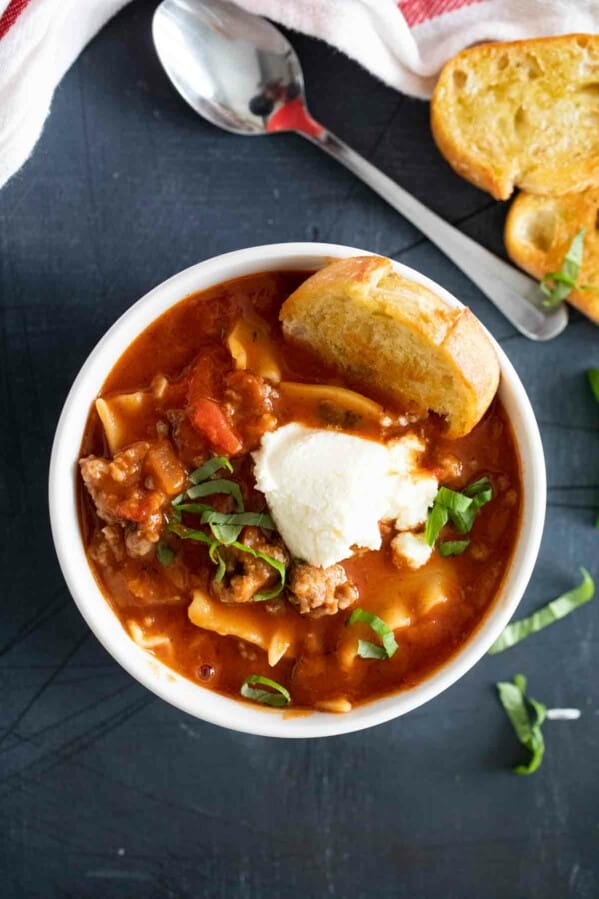 overhead view of a bowl of Lasagna Soup topped with ricotta cheese