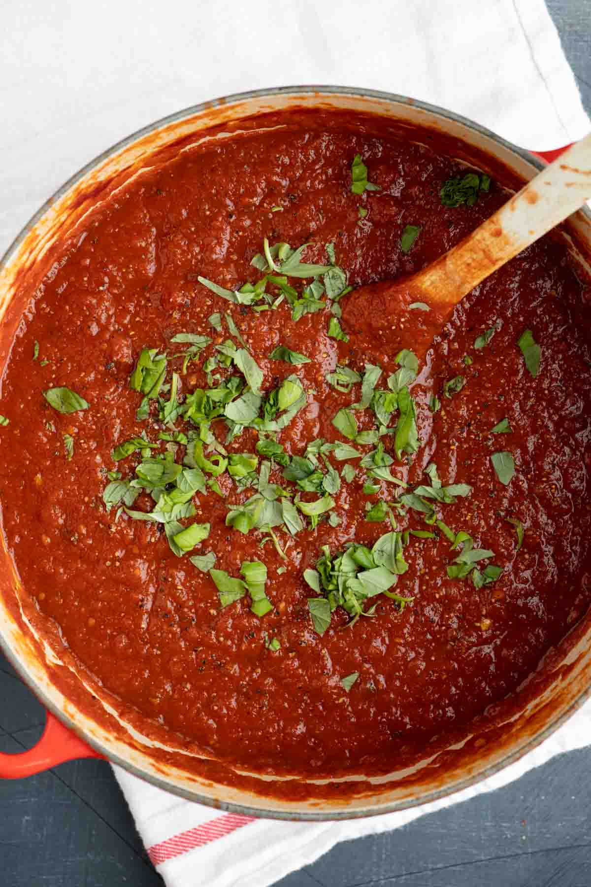 overhead view of Dutch oven filled with marinara sauce.