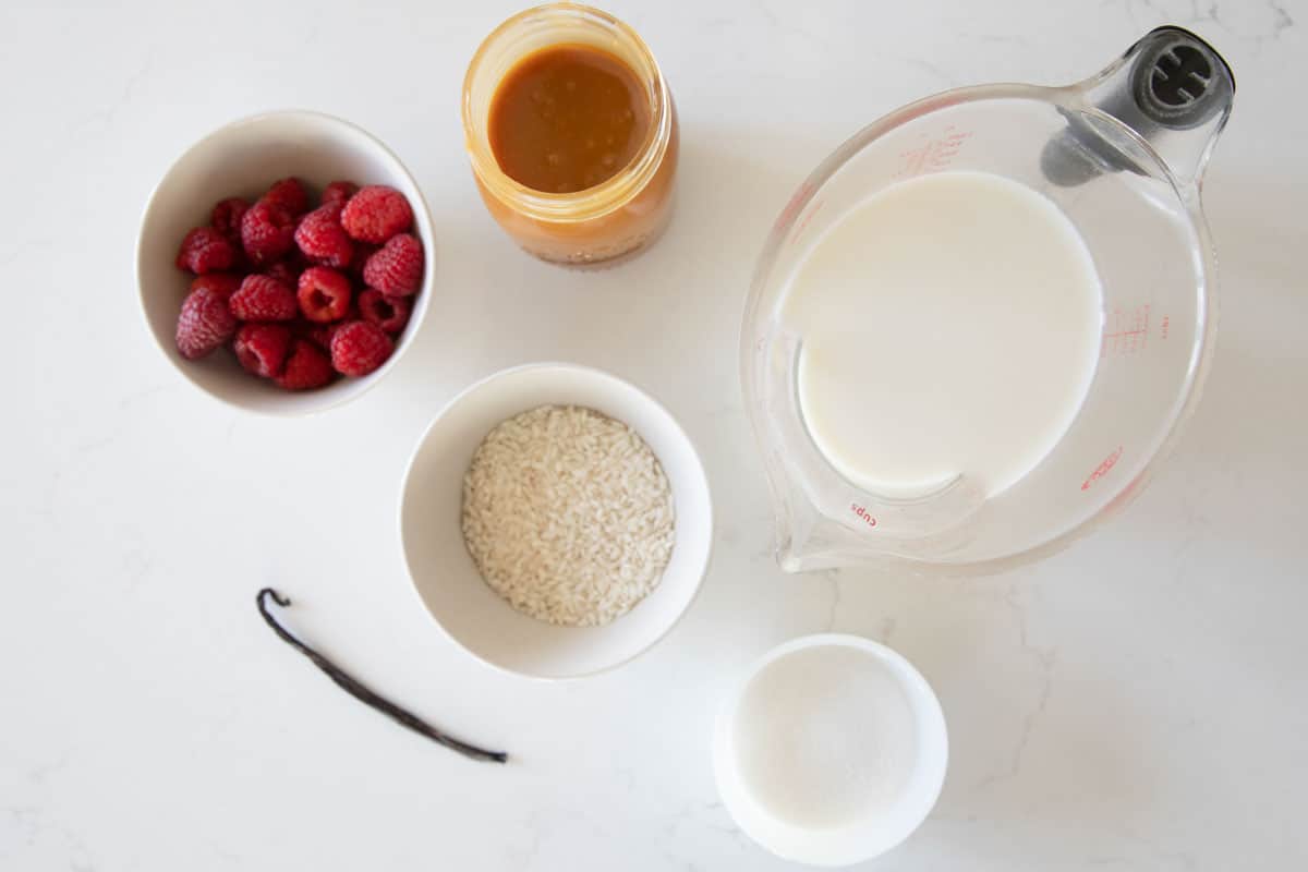 Ingredients needed to make rice pudding with salted caramel and raspberries.