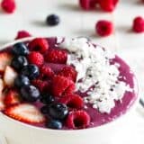 smoothie bowl topped with fresh fruit and coconut