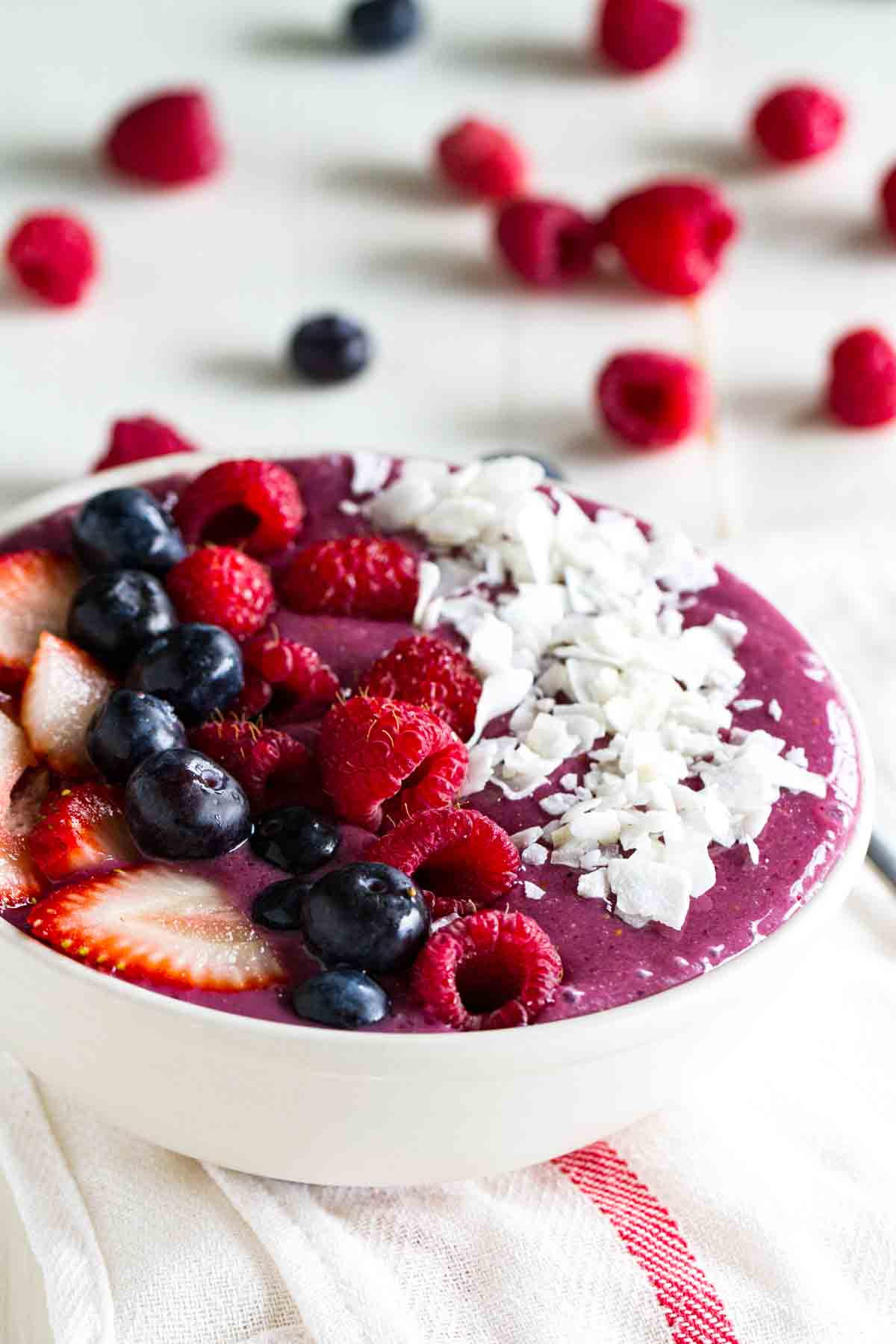 smoothie bowl topped with fresh fruit and coconut