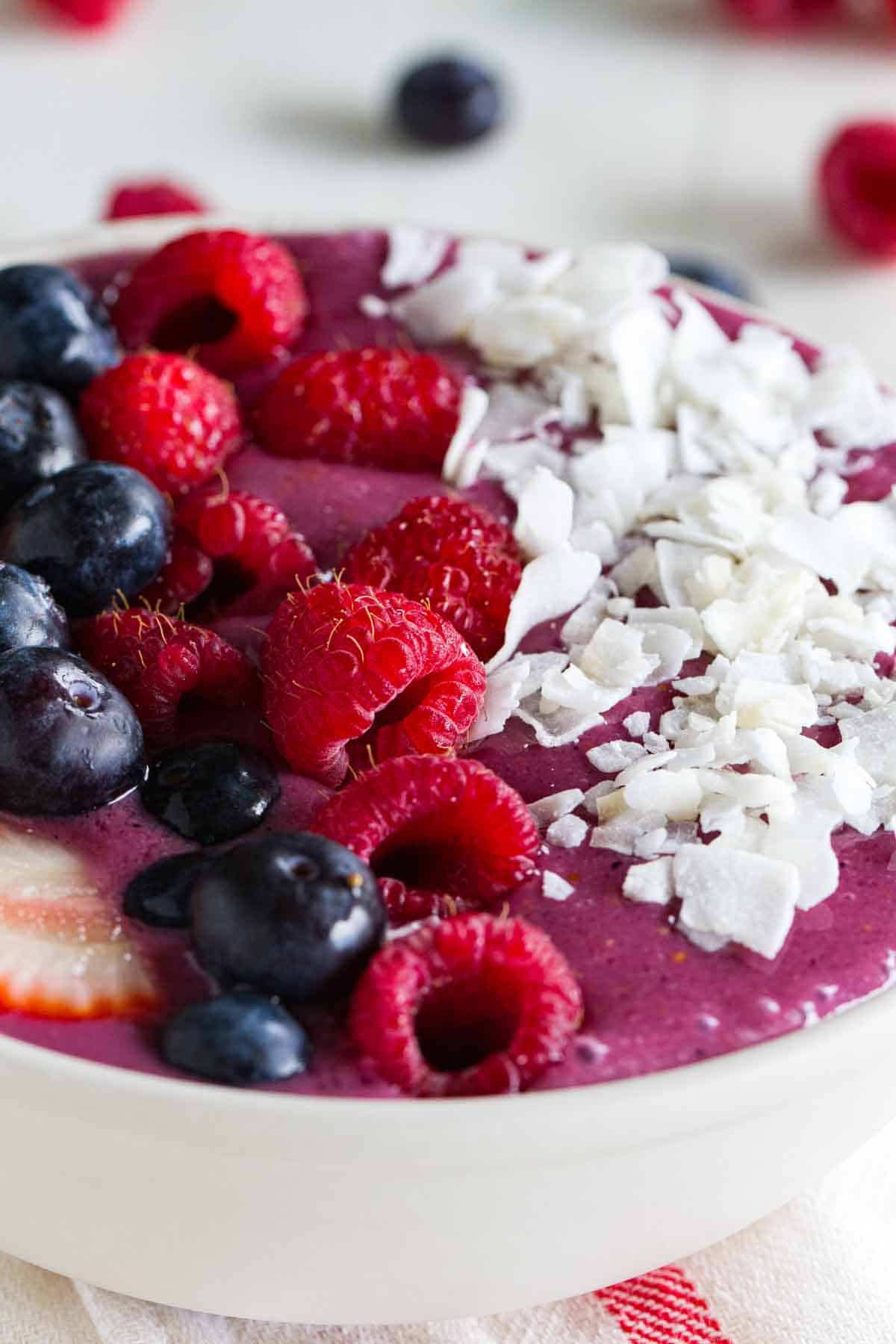 close up of smoothie bowl with berries and coconut