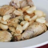 Chicken with 40 cloves of garlic in a serving dish.