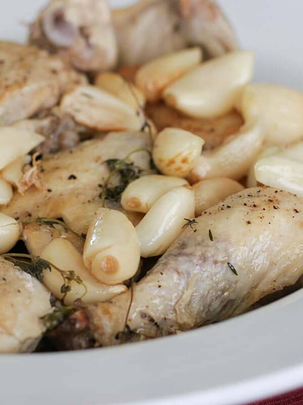 Chicken with 40 cloves of garlic in a serving dish.