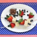 overhead view of 2 4th of July Dessert Kabobs with pound cake, blueberries and strawberries
