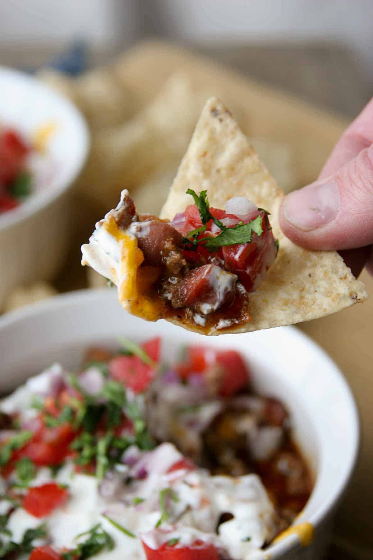 tortilla chip with 7 layer chili dog dip