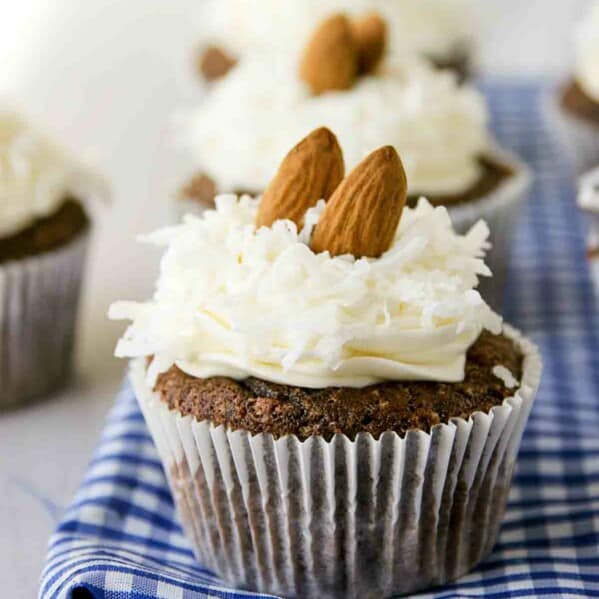 Almond Joy Cupcakes in a row on top of blue and white fabric