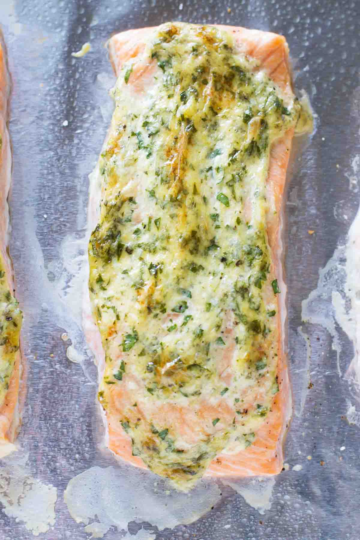 overhead view of a piece of amazingly moist salmon topped with herbs