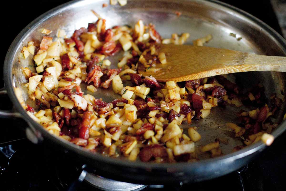 cooking apples and bacon together in a skillet