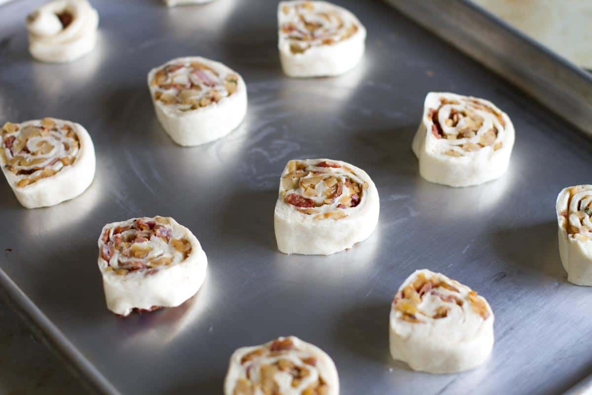 unbaked apple bacon pinwheels on a baking sheet