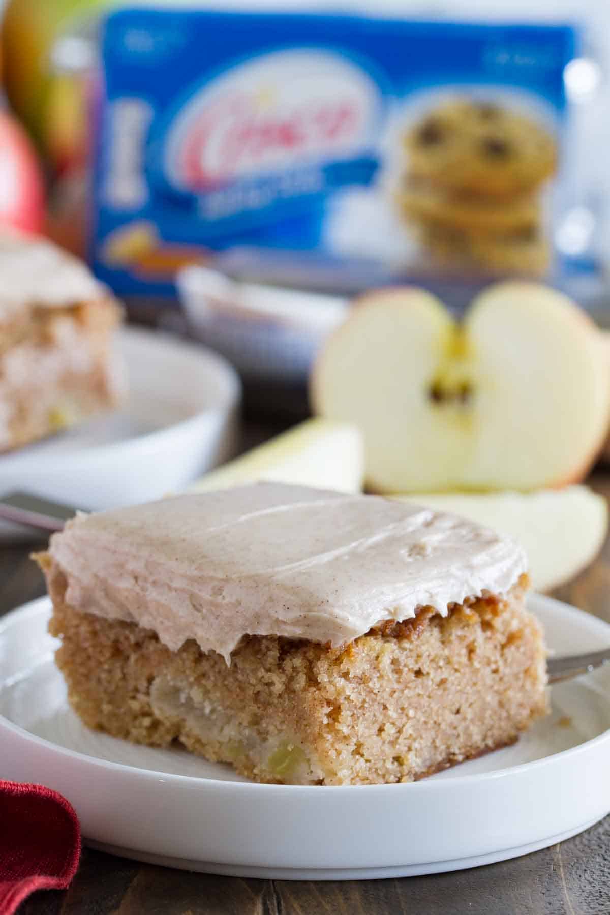 slice of apple cinnamon sheet cake with ingredients behind