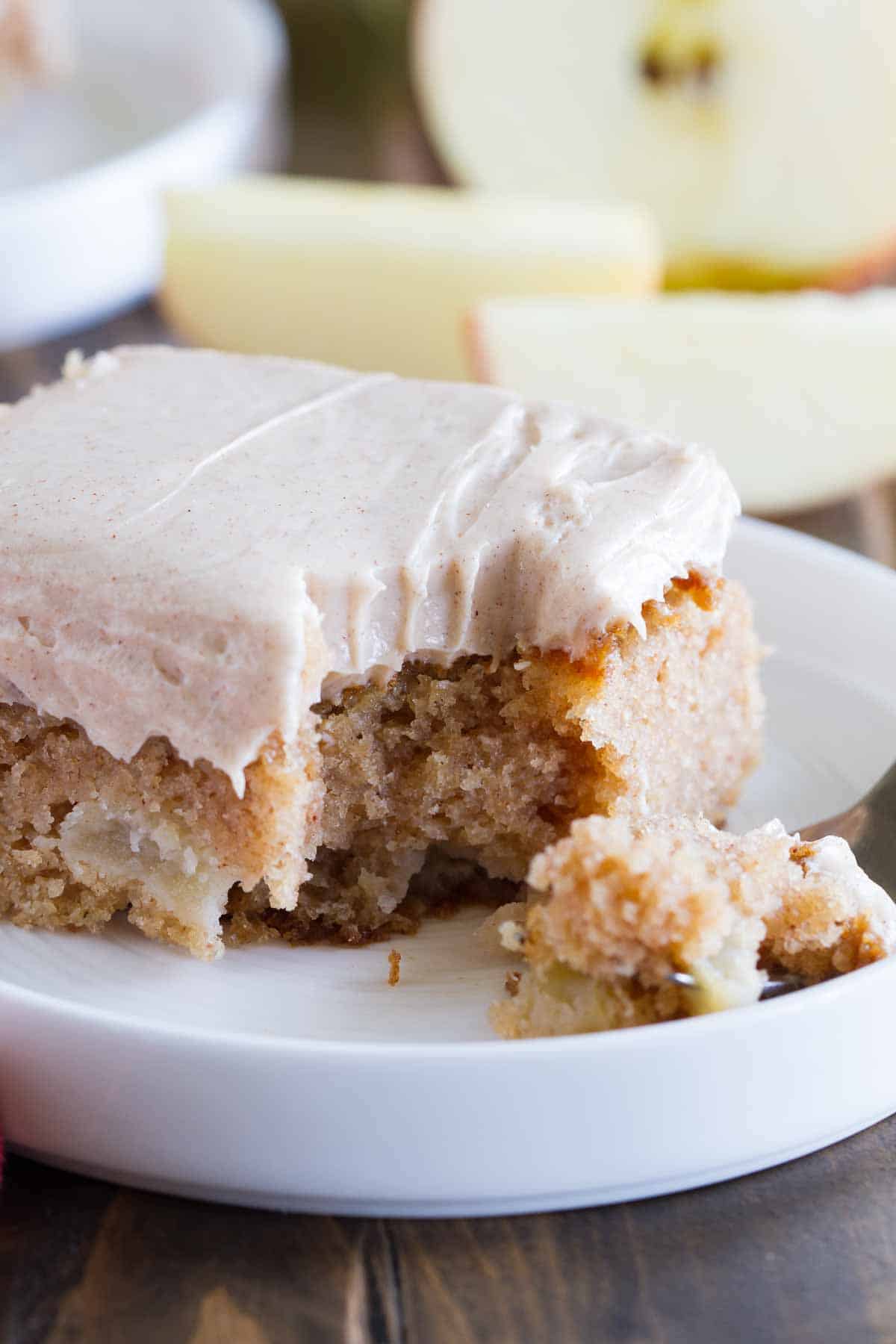 forkful of apple cinnamon sheet cake on a plate