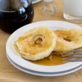 Apple Pancake Rings on a plate served with syrup