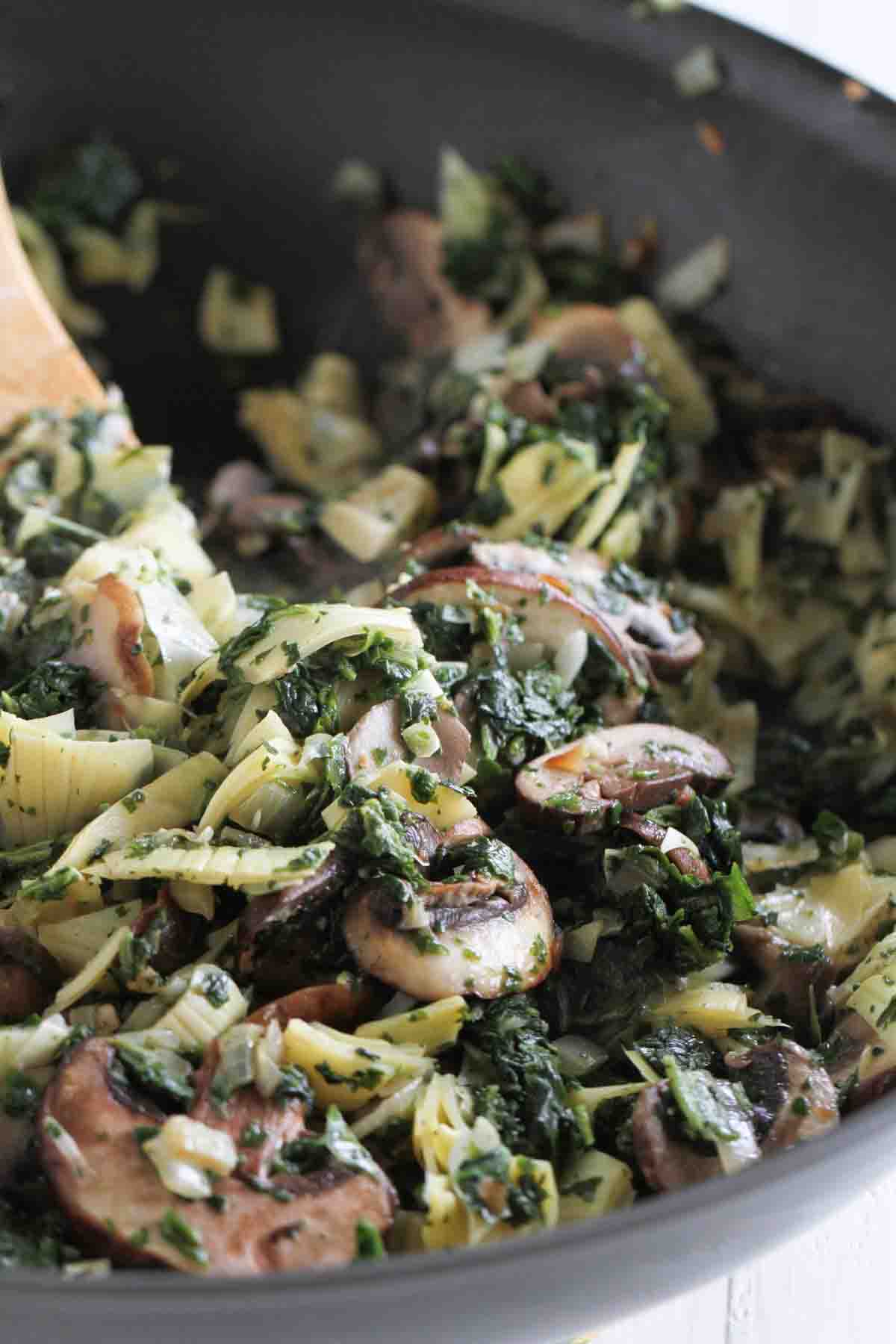 filling for artichoke and spinach enchiladas in a skillet