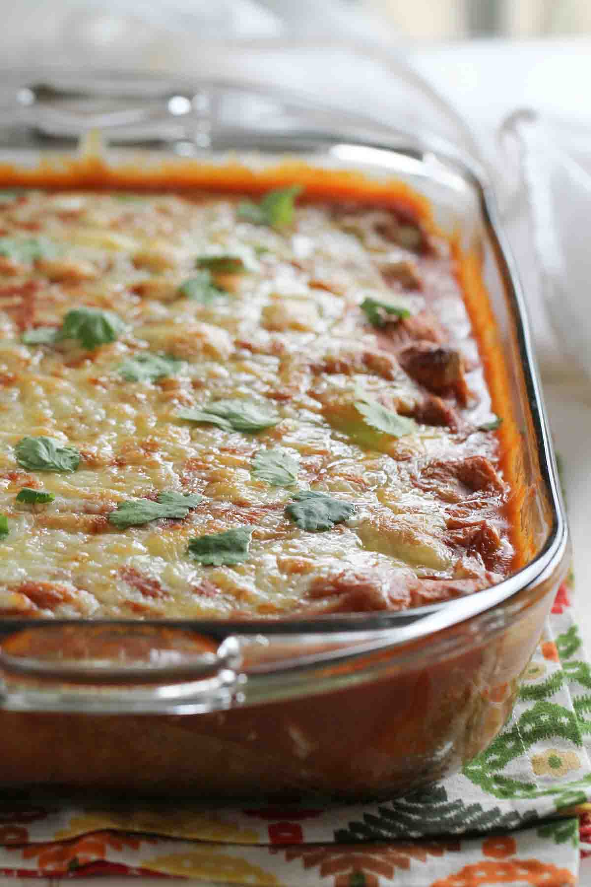 baking dish with artichoke and spinach enchiladas