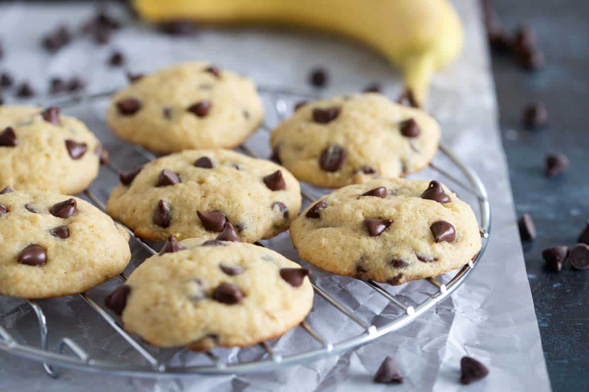 Soft banana cookies are filled with chocolate chips. These Banana Chocolate Chip Cookies are the perfect use for overripe bananas. Banana chocolate chip cookies on a cooling rack