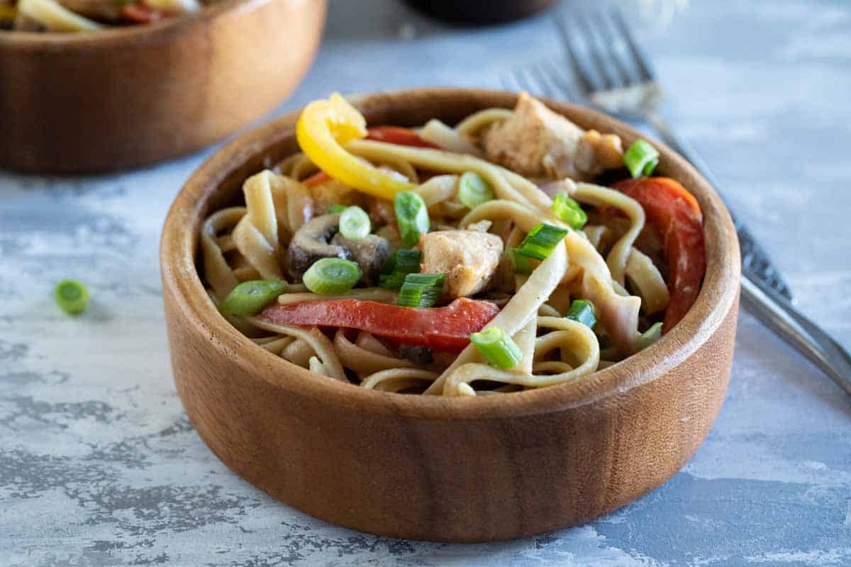 bowl filled with cajun chicken pasta with bell peppers