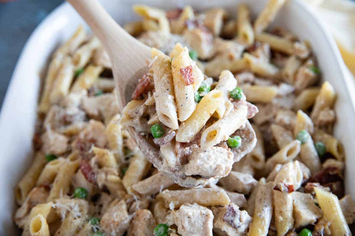 Casserole dish with Chicken Bacon Pasta with peas.