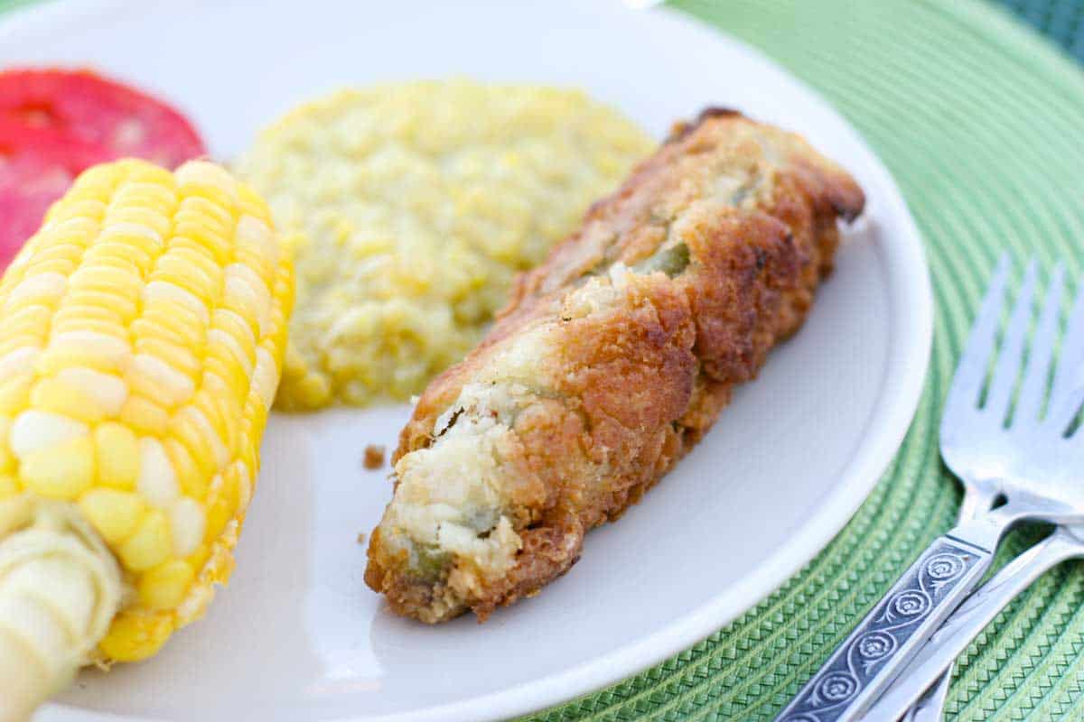 chile relleno on a plate with corn and squash