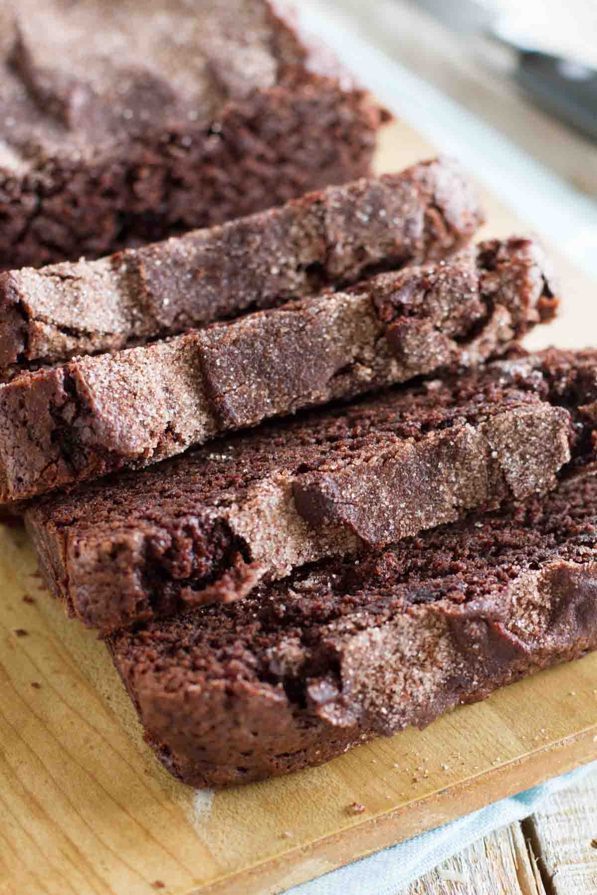 loaf of sliced chocolate cinnamon bread on a cutting board