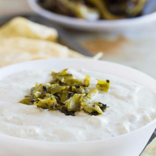 bowl filled with creamy hatch green chile dip with chopped chiles on top