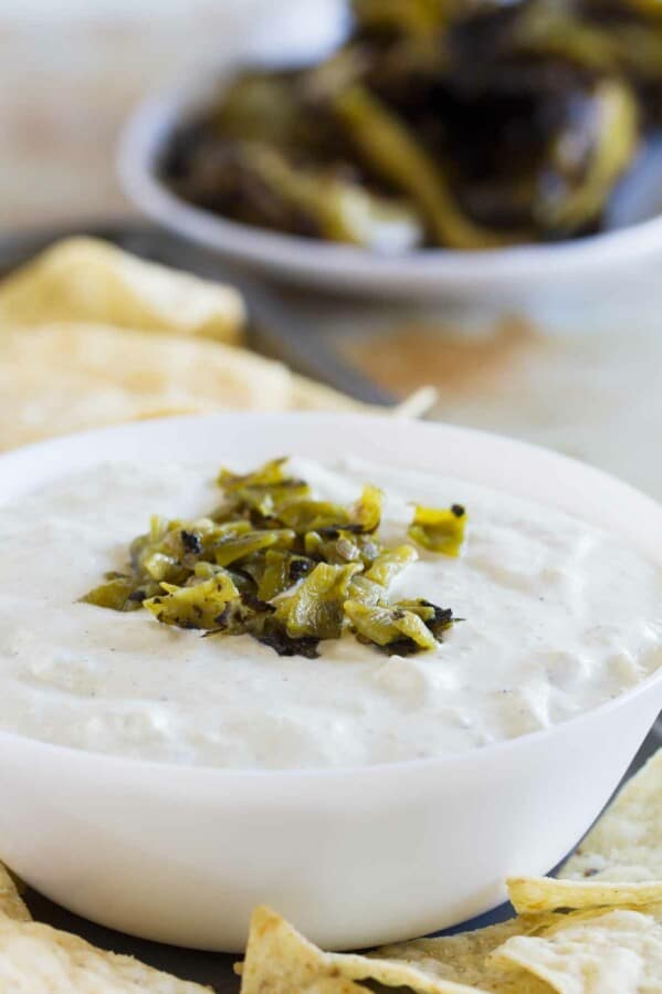 bowl filled with creamy hatch green chile dip with chopped chiles on top