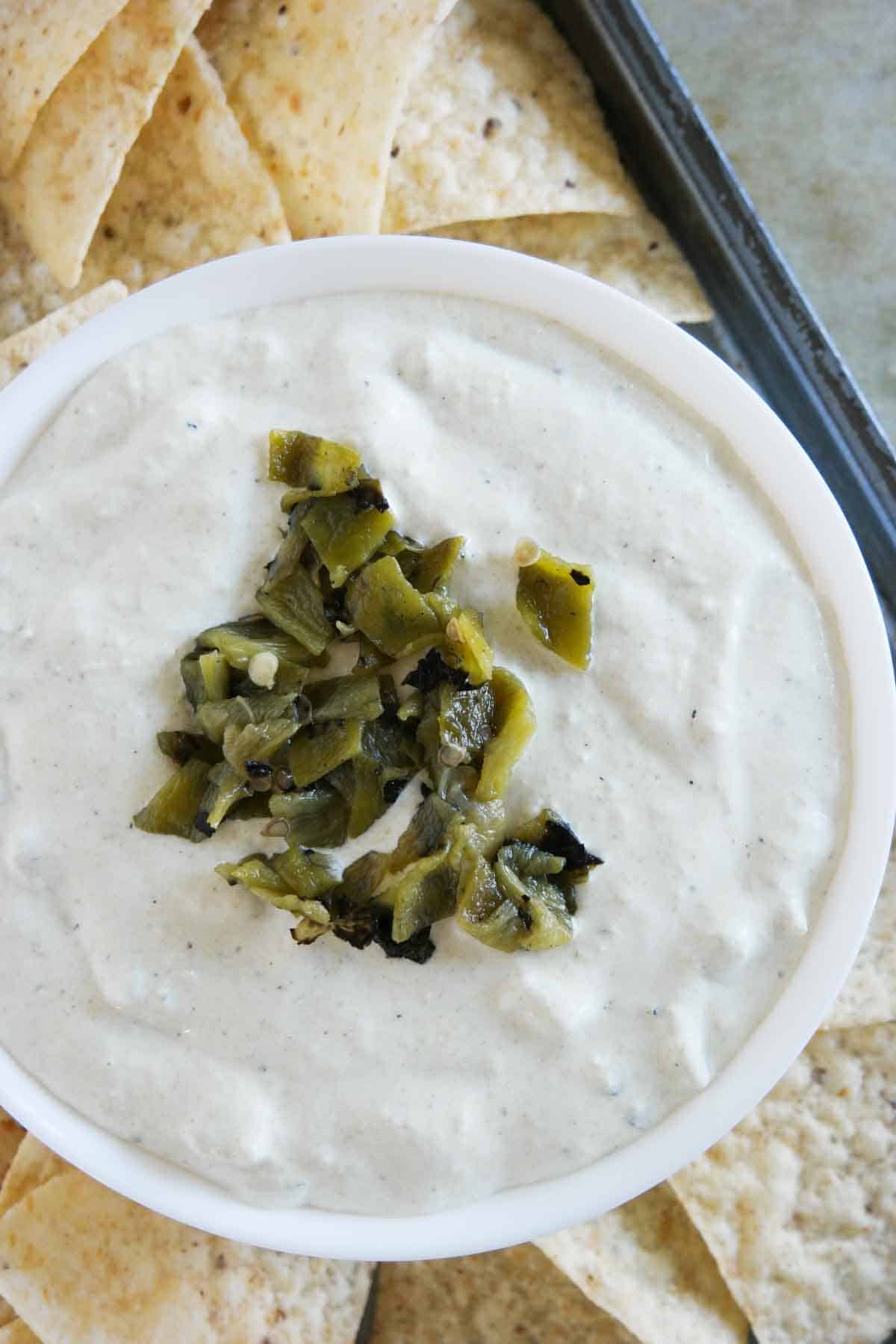 overhead view of green chile dip surrounded by chips