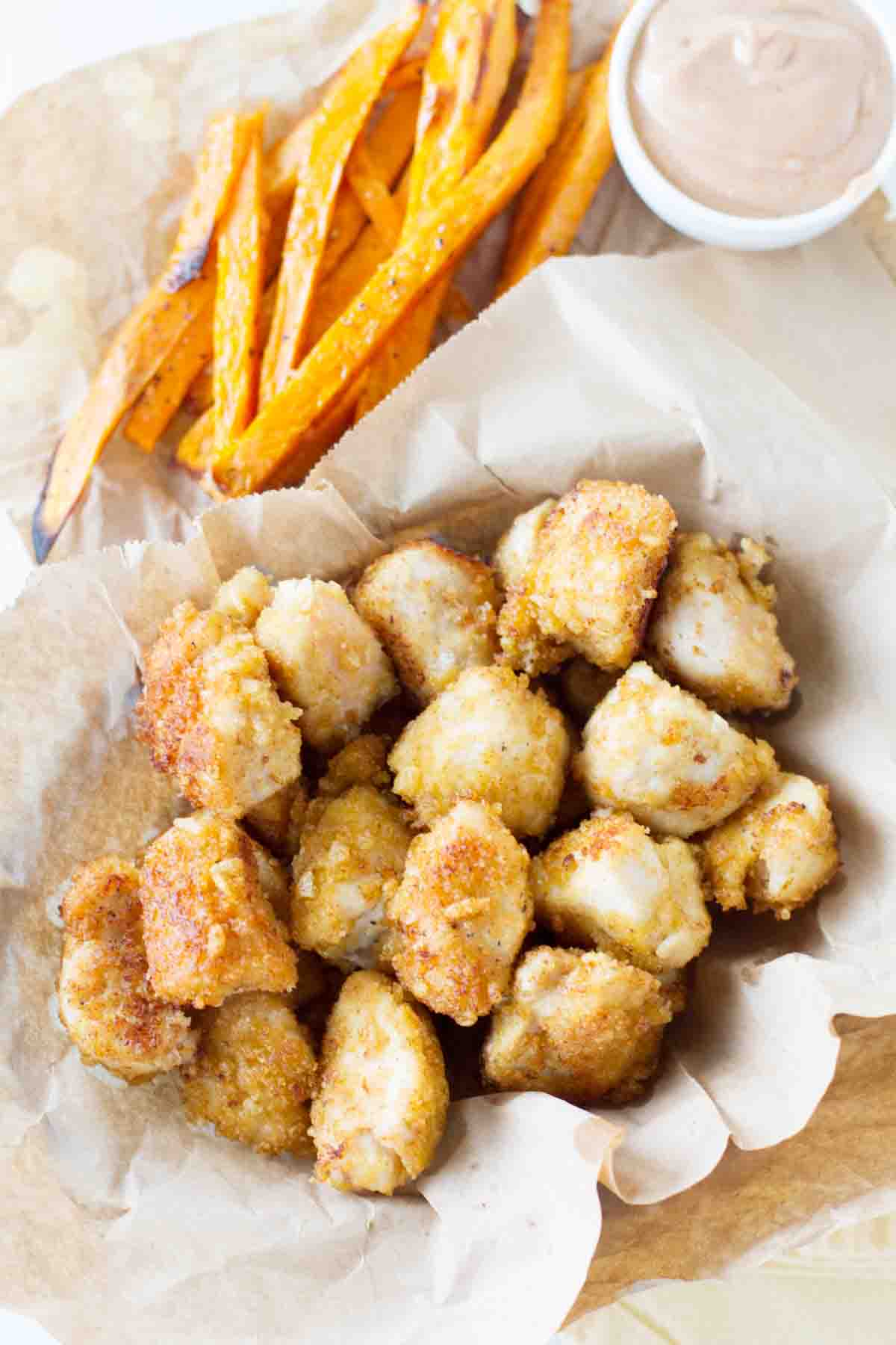 Overhead view of Crispy Chicken Nuggets with sweet potato fries.