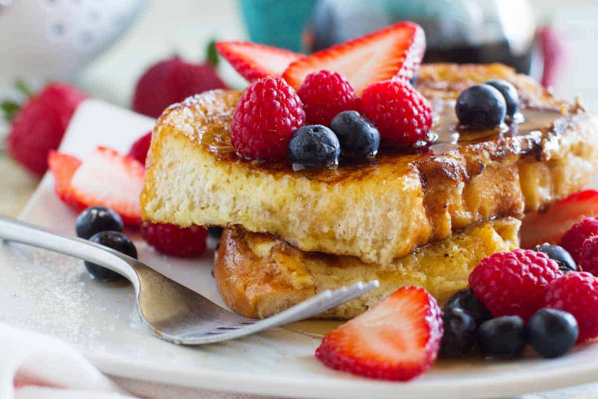 ice cream soaked french toast topped with syrup and fresh berries
