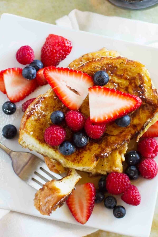 overhead view of stack of Ice Cream Soaked French Toast topped with berries