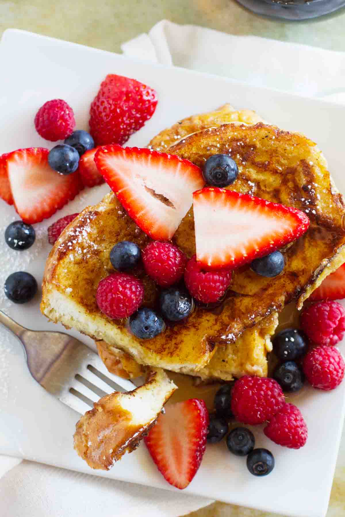 overhead view of stack of Ice Cream Soaked French Toast topped with berries