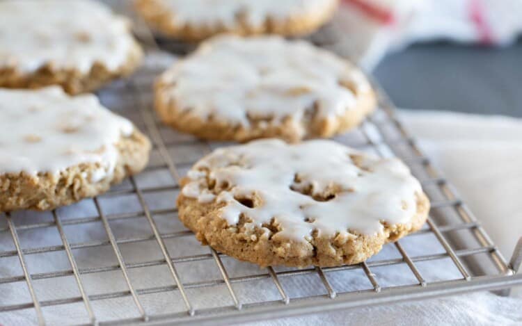 Iced Oatmeal Cookies on a cooling rack.