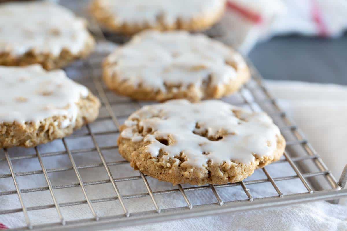 Iced Oatmeal Cookies on a cooling rack.