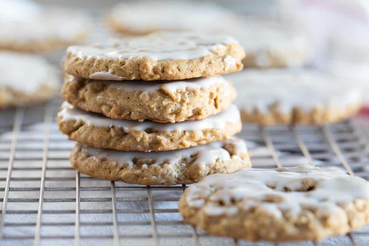 four iced oatmeal cookies stacked on top of each other