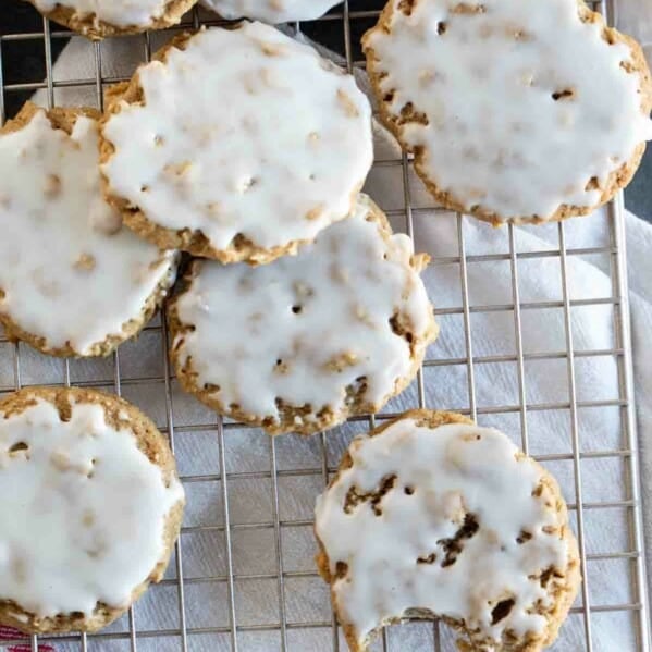 overhead view of iced oatmeal cookies on a baking sheet